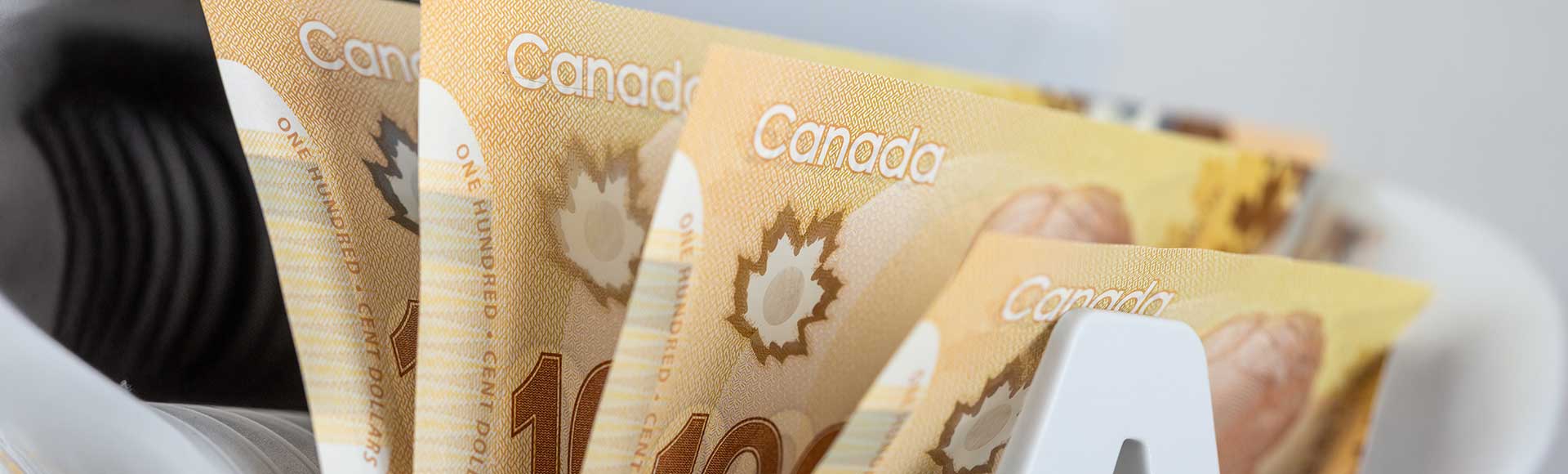 Canadian dollars in a bill counter. Financial concept. Canada money. Business background. Close up