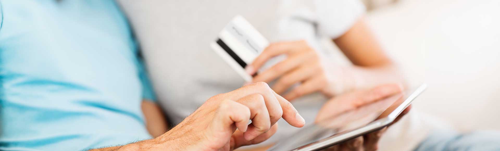 Couple Using Digital Tablet And Credit Card